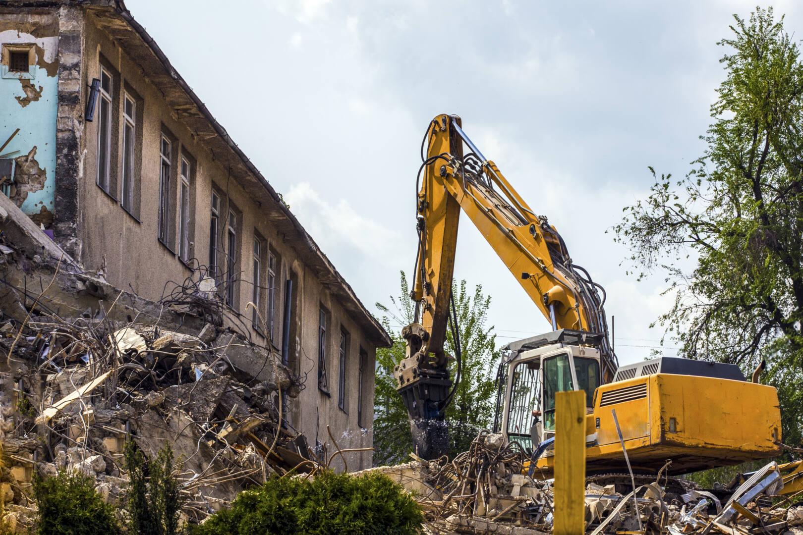 demolition of a building with a hydraulic excavator